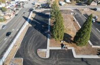 Aerial view of a newly paved parking lot with construction going on around it